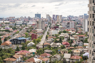 ariel panoramic view of old city in forest and skyscrapers from the mountains