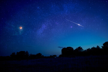 Landscape silhouette of a evening sky with crescent Moon eclipse, meteor, shooting star and planets. © astrosystem