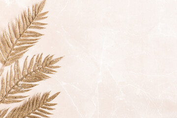 Christmas composition. Golden leaves onmarble beige background. Christmas, winter, new year...