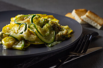 Fried zucchini with melted cheese and garlic