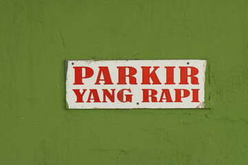 Instruction to parking cars neatly in Bahasa Indonesia "Parkir Yang Rapi"