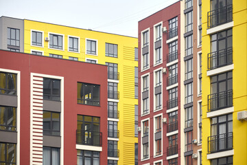 View of the facades of multi-colored multi-storey residential buildings. Fragment of a multi-storey residential building.