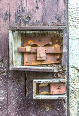 Vintage front door in the medieval city of Italy. Ancient streets of the city, beautiful doors and unusual door handles in the shape of a lion's head.