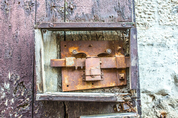 Vintage front door in the medieval city of Italy. Ancient streets of the city, beautiful doors and unusual door handles in the shape of a lion's head.