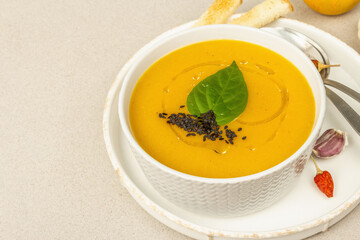Pumpkin cream soup. Traditional autumn food. Hot dish, ripe vegetables, fragrant spices