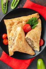 Concept of tasty food with samsa on dark textured background