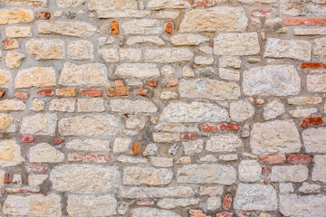 Stone antique old wall as a background or texture. Vintage background of a fortress wall in loft...