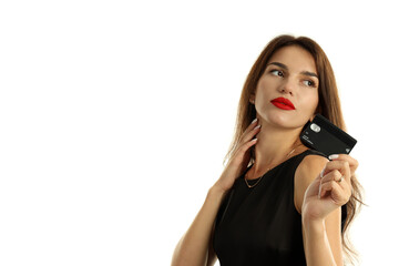 Girl in black dress with credit card isolated on white background