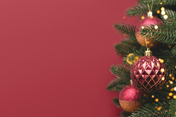 Trendy Christmas decorations. New Year ornaments in front of red background with copyspace.