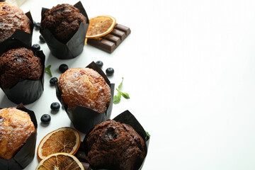 Concept of delicious food with chocolate muffins on white background
