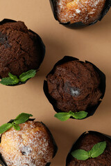 Chocolate muffins with mint on beige background