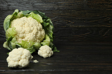 Concept of tasty food with cauliflower on wooden background