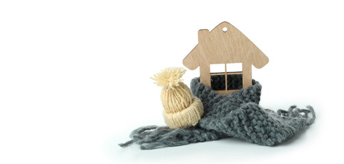 Wooden house with knitted clothes isolated on white background