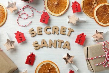 Secret Santa and Christmas composition on white wooden background