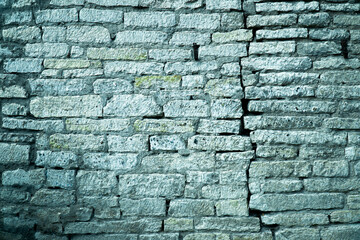 Blye wall. crack in the brick wall of white gray brick