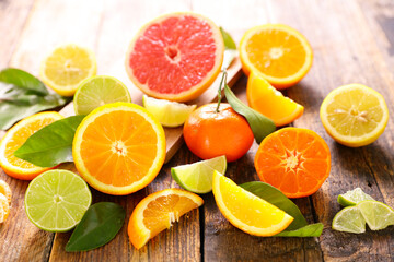 Fototapeta na wymiar various citrus fruits and leaves - orange, grapefruit, lemon