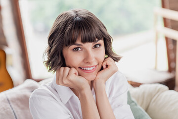 Photo of think brunette hairdo millennial lady hands face wear white shirt alone at home