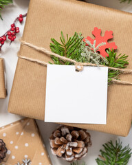 Christmas present with square blank gift tag top view, Mockup
