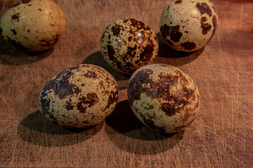 Quail eggs on the table. Several spotted quail eggs. Food