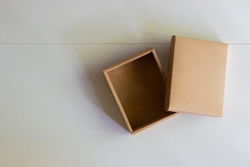 A craft box on white backboard with nature light. 