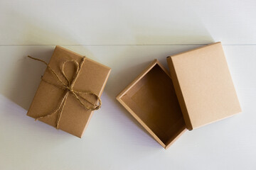A craft gift boxes with robe on white wooden table.