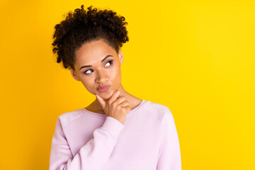 Photo of young attractive minded woman look empty space brainstorm isolated on yellow color...
