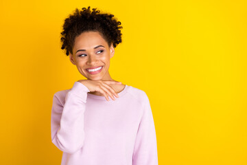 Obraz na płótnie Canvas Photo of young happy beautiful dark skin woman look empty space smile isolated on yellow color background