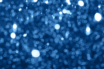 Blue sparkling glitter bokeh background, christmas abstract defocused texture. Holiday lights