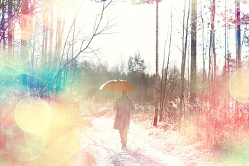 Fototapeta premium winter walk with an umbrella / man in a coat with an umbrella, walk against the backdrop of the winter landscape, winter view