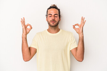 Young caucasian man isolated on white background relaxes after hard working day, she is performing yoga.