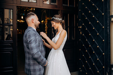 The newlyweds are standing at the church gate. Marriage