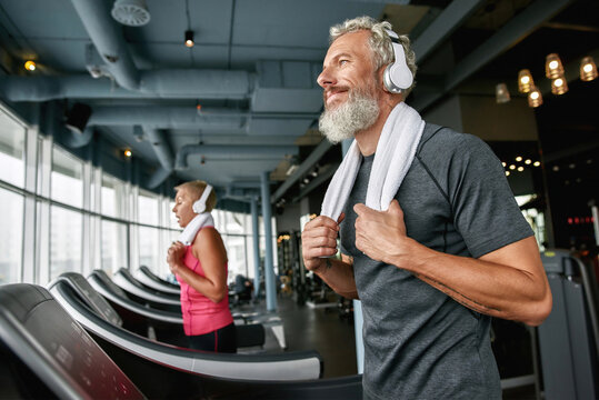 Happy senior man enjoying excercising in gym