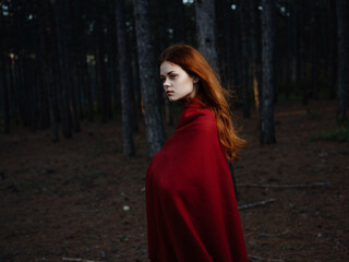 Naklejka premium pretty red-haired woman in red plaid forest rest