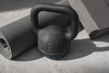 Naklejka na ściany i meble Kettlebell and yoga mat on the floor at home. gym equipment.