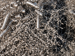 Curved metal shavings from the production. Attractive production waste, close up