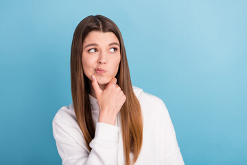 Photo portrait girl looking blank space touching chin wearing sportswear isolated pastel blue color background