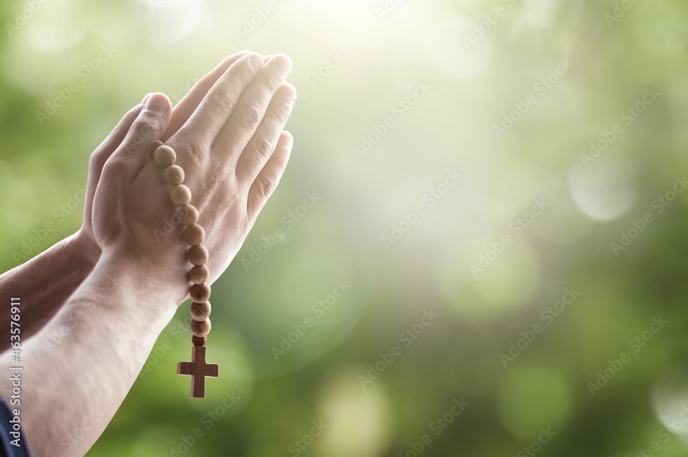 Wall mural Christian human hands holding a cross holy and worship Pray to God with a natural background.