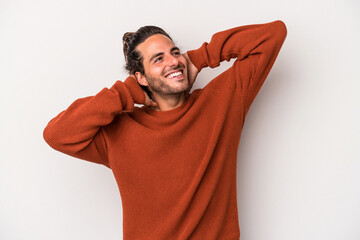 Young caucasian man isolated on gray background feeling confident, with hands behind the head.