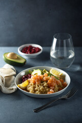 Healthy quinoa bowl with shrimps and avocado