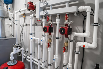 House heating system with modern plastic pipes, manometers and tubes close up in boiler room.
