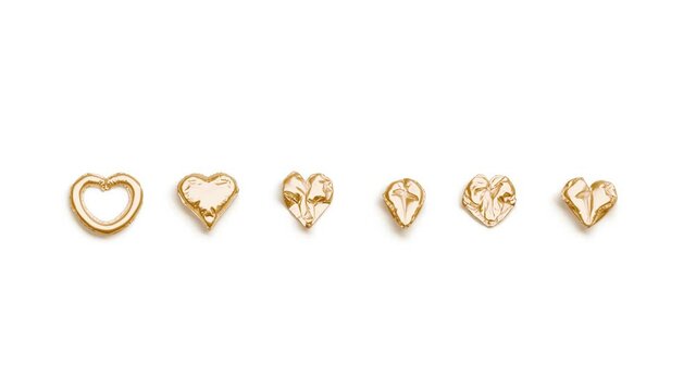 Gold balloon font with heart symbol, looped inflation and deflation, 3d rendering. Helium typeset with love sign for banner, 4k video, top view. Golden decorative hearts for valentine party template.