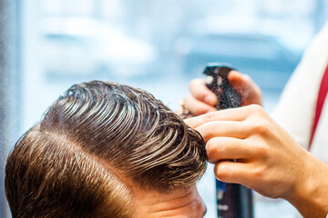 barbershop, the master does his hair, in the frame the hands of the master with the tool