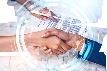 Businesswomen wearing formal suit are shaking hands with each other