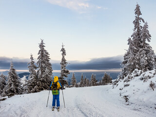 ski tour woman skier on the top of the mountains