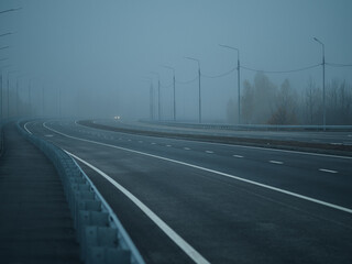 Empty foggy highway road. Foggy gloomy morning