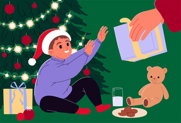 Obraz na płótnie Canvas Kid gets a Christmas present at christmas tree