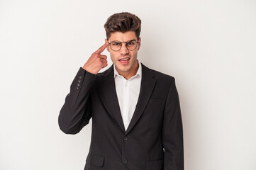 Young business caucasian man isolated on white background showing a disappointment gesture with forefinger.