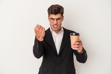 Young business caucasian man holding take away coffee isolated on white background showing fist to camera, aggressive facial expression.