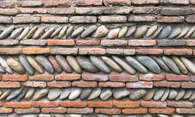 Old wall of red brick and stones.
