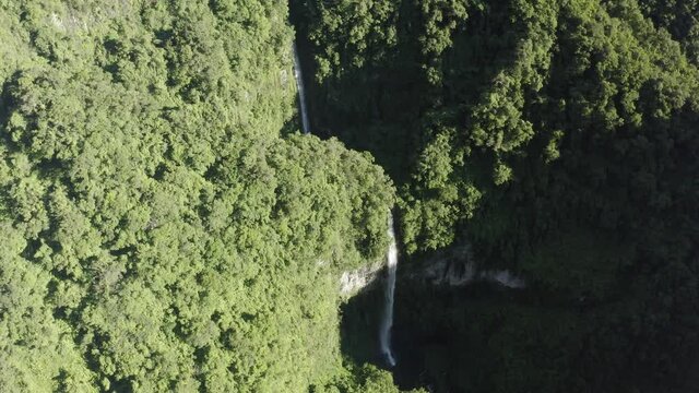 Aerial view of Cascade de La Grande Ravine, a beautiful waterfall among the wild mountains near Saint Benoit, Reunion.